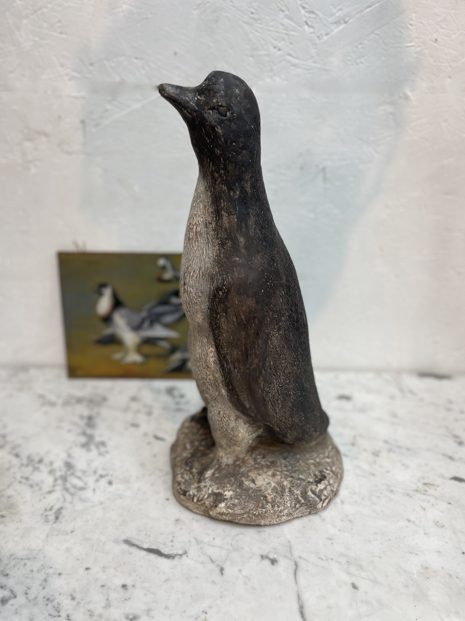 Vintage garden statue of a proud penguin.