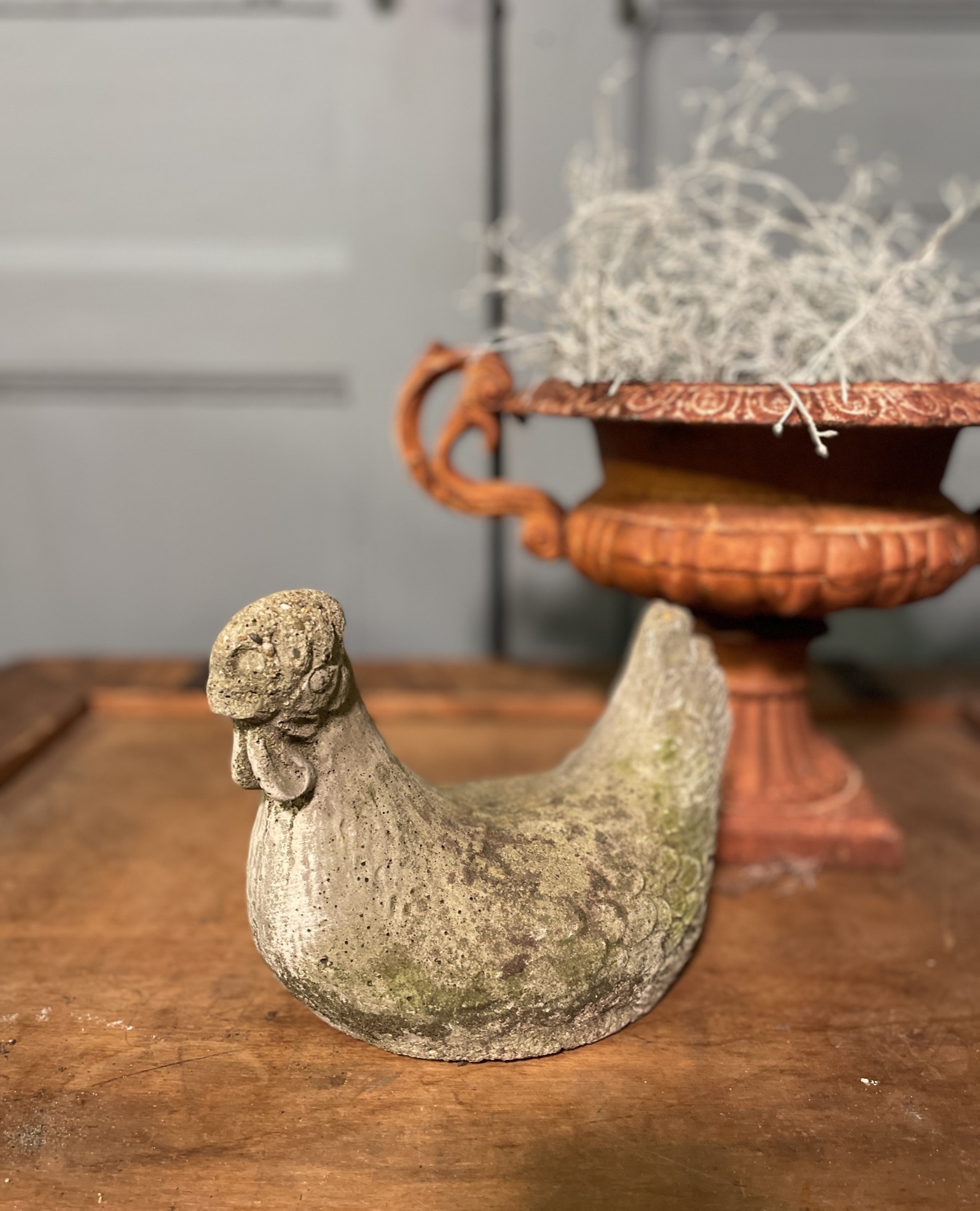 Old statue of a chicken with wear