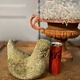 Old statue of a chicken with wear