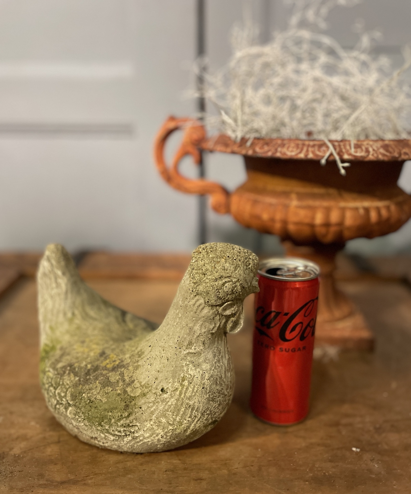 Old statue of a chicken with wear