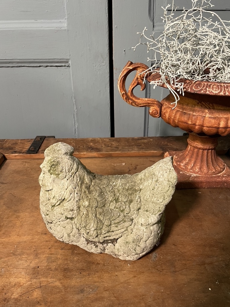 Vintage garden statue brooding chicklet