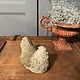 Vintage garden statue brooding chicklet