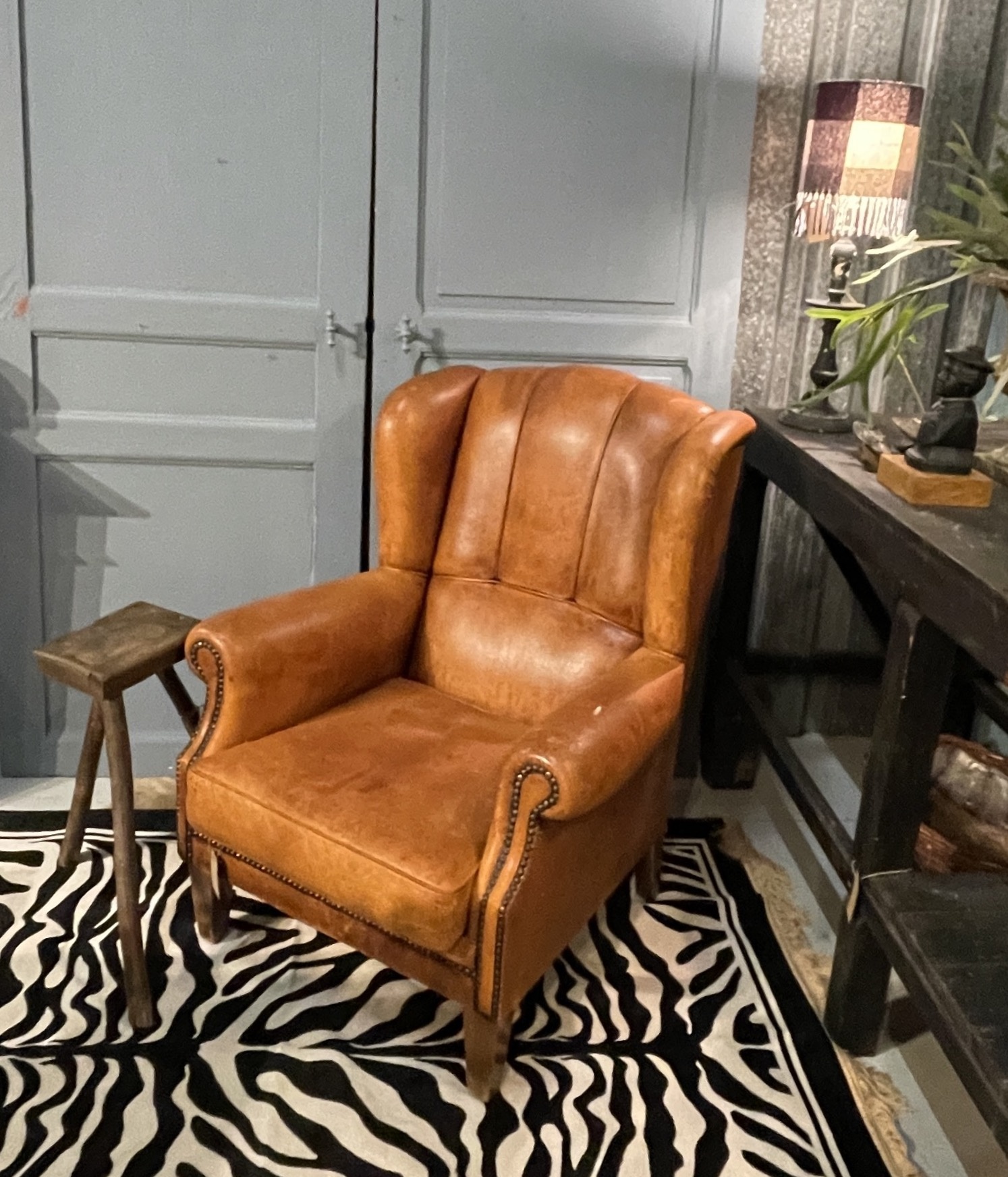 Almost antique leather wingback armchair with charming details
