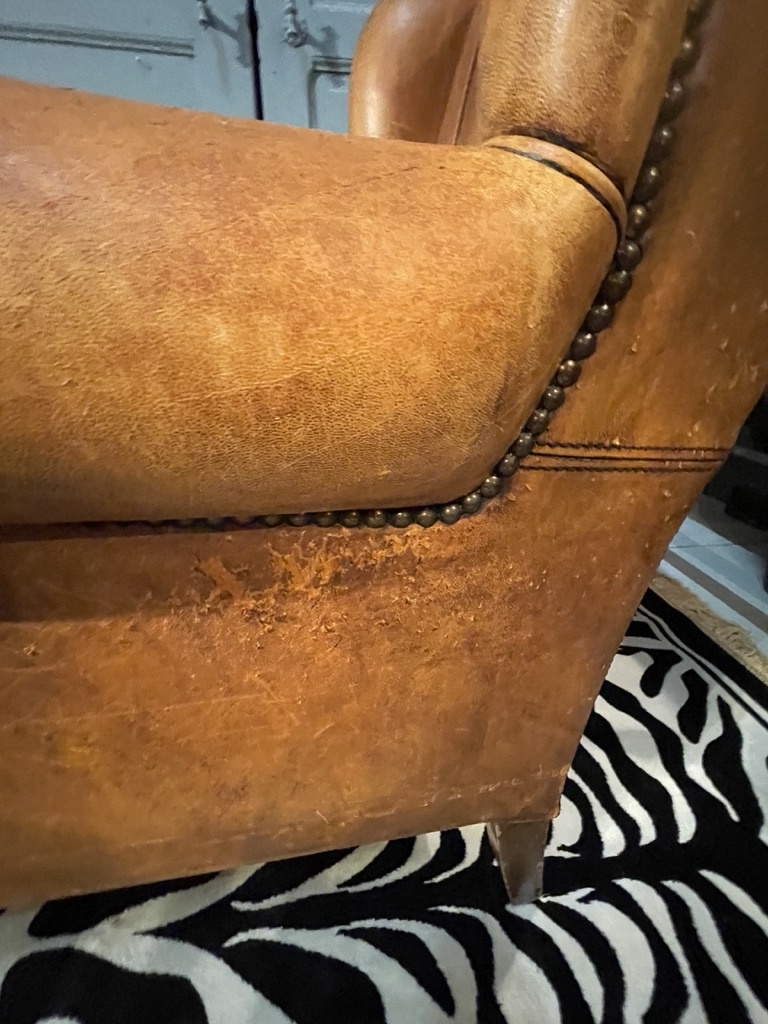 Almost antique leather wingback armchair with charming details