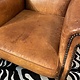 Almost antique leather wingback armchair with charming details