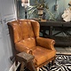 Almost antique leather wingback armchair with charming details