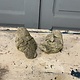 Pair of cement birds with a smile on their face