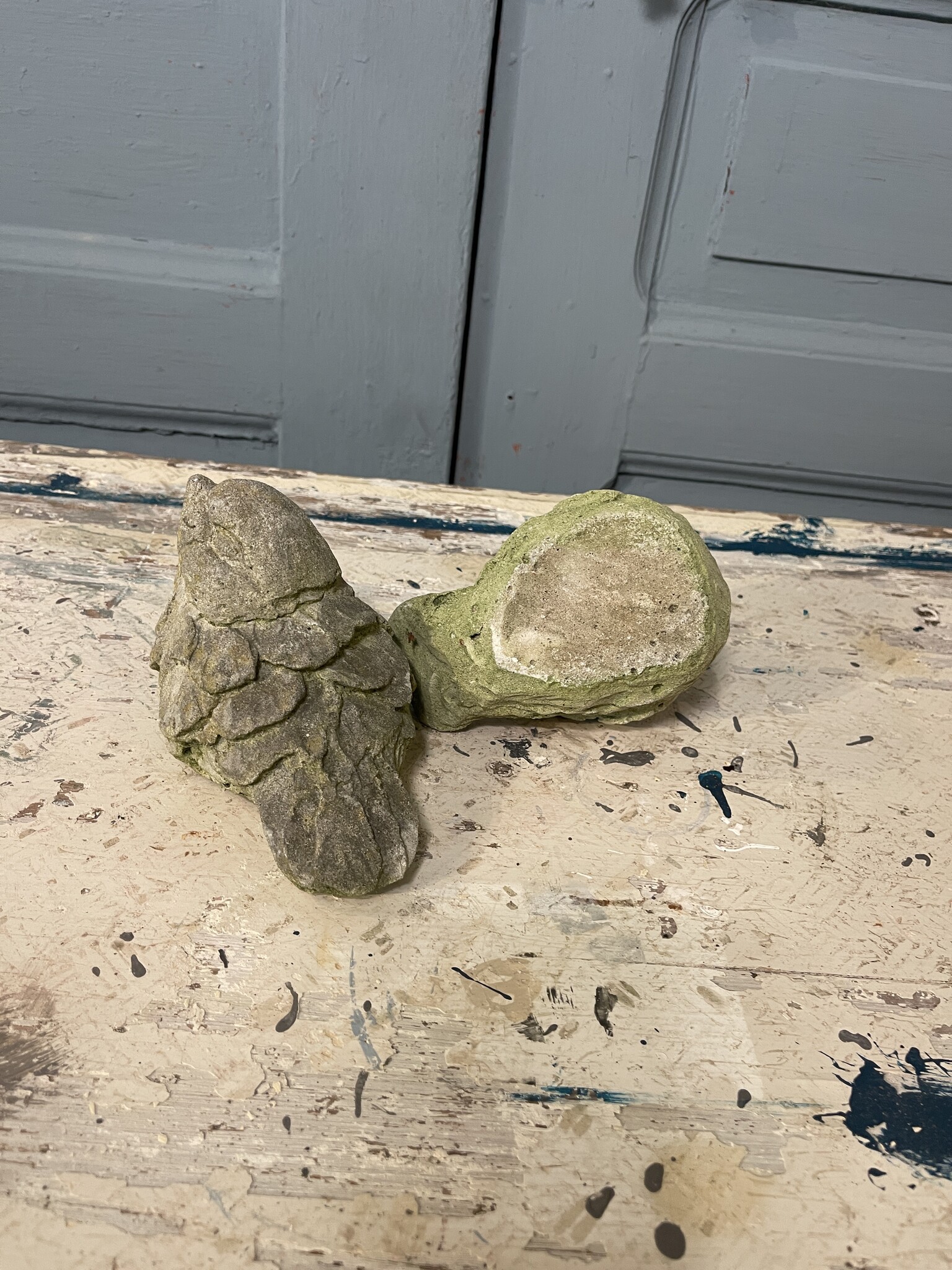 Pair of cement birds with a smile on their face