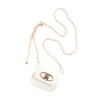 Tasje beige mini schoudertas met een draaisluiting