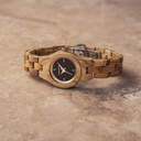 The Lily watch from the FLORA Collection consists of olive wood that has been hand-crafted to its finest slenderness. The Daisy dial is made of a black coloured stainless-steel that has a shiny touch and rosegold coloured details.