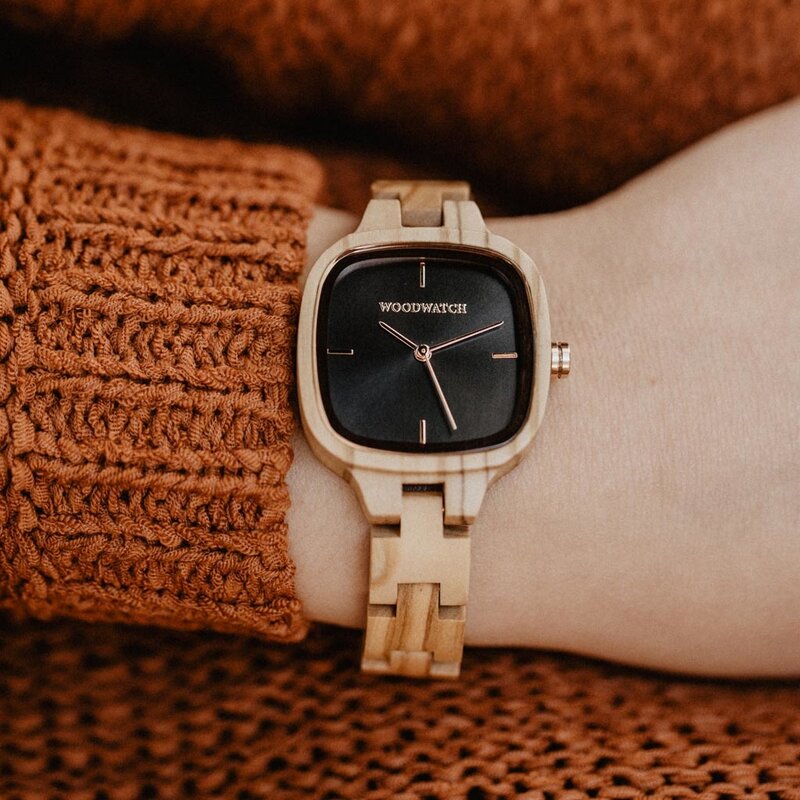 An enduring fashion icon. The CITY Icon features a square case with a black dial and rose gold details. The watch band consists of soft olive wood that has been hand-finished to perfection and to create our latest small-band design.