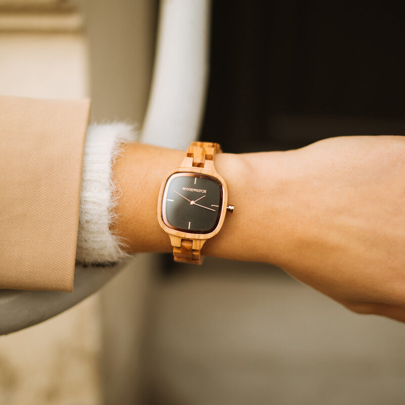 An enduring fashion icon. The CITY Icon features a square case with a black dial and rose gold details. The watch band consists of soft olive wood that has been hand-finished to perfection and to create our latest small-band design.