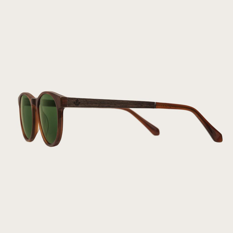 ELLIPSE Classic Havanas Camo sfoggia la caratteristica montatura rotonda tartarugata giallo scuro geometrica con stanghette verde militare  lenti scure. In resistente bio-acetato italiano firmato Mazzucchelli con stanghette in palissandro naturale in eban