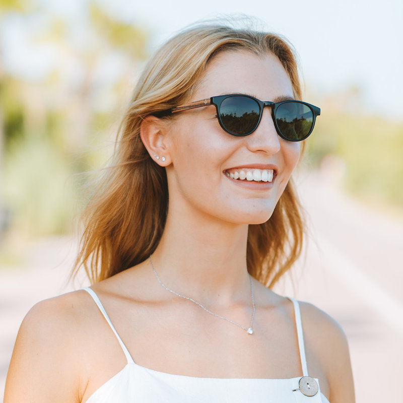 "La paire de lunettes l’ELLIPSE Black Camo poséde  un cadre rond en noir avec des verres en camouflage vert. Fabriquée à partir de bois durable et du bioacétate Mazzuchelli Italien avec des branches et écaille de tortue en bois de rose et des manchons en