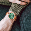 The AURORA Collection breaths the fresh air of Scandinavian nature and the astonishing views of the sky. This light weighing watch is made of olive wood, accompanied by a green stainless-steel dial with golden details.<br />
The watch is available with a woode