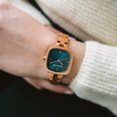 The CITY Atomic features a 30mm square case with a blue dial and golden details. The watch band consists of natural mahogany wood that has been hand-finished to perfection and to create our latest small-band design.