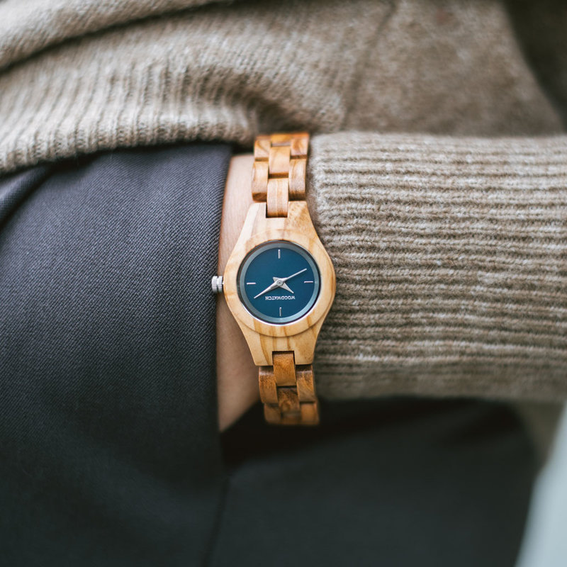 The Iris watch from the FLORA Collection consists of soft olive wood that has been hand-crafted to its finest slenderness. The Iris features a midnight blue dial with silver coloured details.