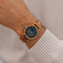 The men's CLASSIC Sailor watch has a classy slim case while featuring a unique moonphase movement and two extra subdials. The watch is made of East African Kosso Wood and features a blue dial and golden-colored details, perfectly matching the AURORA Ocean