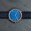 A renewed MINIMAL design with a timeless look that matches any occasion. Featuring a thin, steel case, and walnut bezel and blue dial. Comes with a new watch strap, designed from the ground up to perfectly match the minimal watch case in style and materia