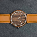 A renewed MINIMAL design with a timeless look that matches any occasion. Featuring a thin, steel case, and walnut bezel and dial. Comes with a new watch strap, designed from the ground up to perfectly match the minimal watch case in style and materials.