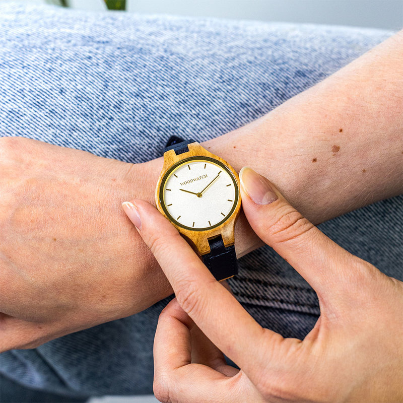 The AURORA Collection breaths the fresh air of Scandinavian nature and the astonishing views of the sky. This light weighing watch is made of European Olive Wood, accompanied by a light stainless-steel dial with a golden highlight and shining golden detai