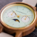 The Selene Mint Essence is crafted from walnut wood, featuring a mint green dial, brown vegan strap, and golden details.