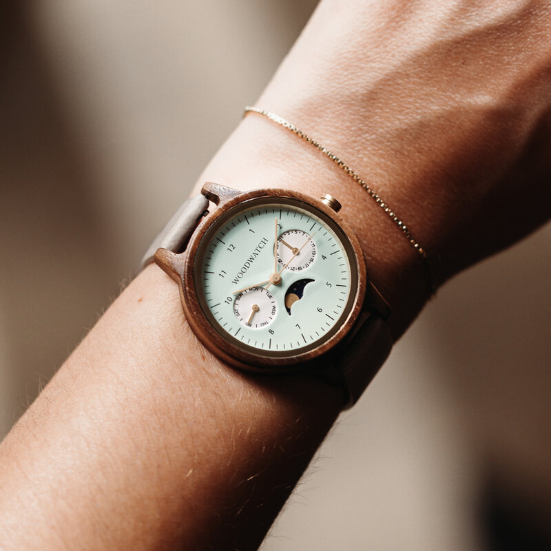 The Selene Mint Essence is crafted from walnut wood, featuring a mint green dial, brown vegan strap, and golden details.
