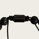 Made with rosewood beads, volcanic beads, dark green natural stone beads, and a matte black brass closure. Adjustable, with 8mm beads to fit most wrist sizes.