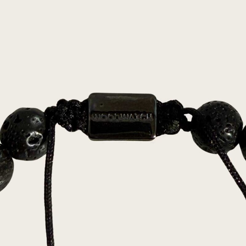 Made with rosewood beads, volcanic beads, dark green natural stone beads, and a matte black brass closure. Adjustable, with 8mm beads to fit most wrist sizes.