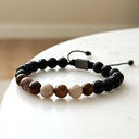 Made with rosewood beads, volcanic beads, dark green natural stone beads, and a matte black brass closure. Adjustable, with 8mm beads to fit most wrist sizes.