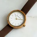 Inspired by contemporary Nordic minimalism. The NORDIC Copenhagen features a 36mm diameter white olive wood case with a white dial and gold details. Handmade from sustainably sourced wood and combined with an ultra soft beige sustainable vegan leather str