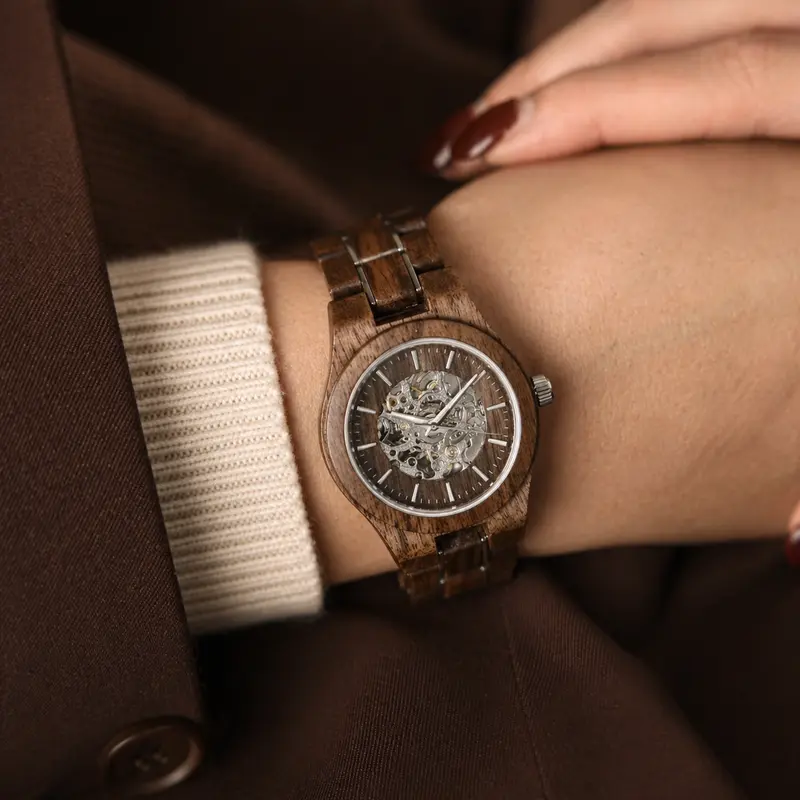 The AUTOMATIC Voyager features a self-winding automatic mechanical movement with 36 hours power reserve. A distinctive optical experience is created through the 33mm case with a silver bezel and partial wooden dial with an open heart, revealing the comple