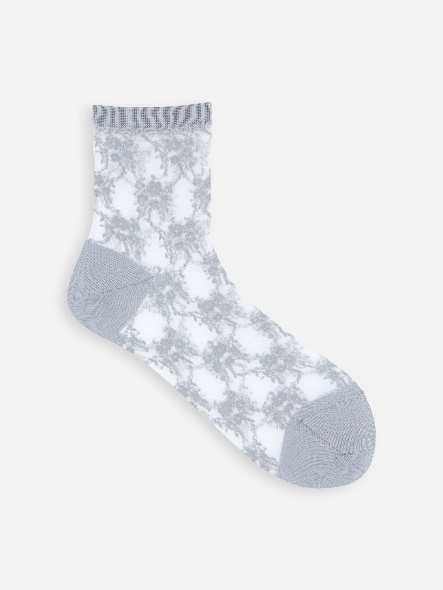 Calcetines tobilleros transparentes con estampado floral.