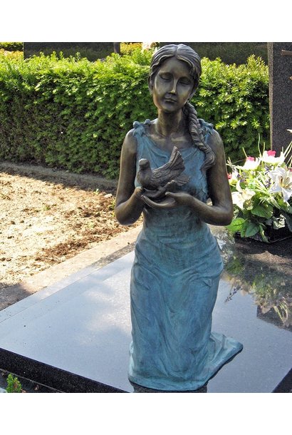 Woman kneeling on gravestone
