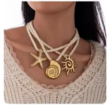Statement Ketting Touw met Zee Bedels Goud – Schelp, Zeester & Zon Hangers