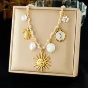 Stainless Steel Bedelketting Wit/Goud – Zon, Maan & Schelp – 40 cm + 5 cm Verlenging