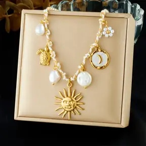 Stainless Steel Bedelketting Wit/Goud – Zon, Maan & Schelp – 40 cm + 5 cm Verlenging