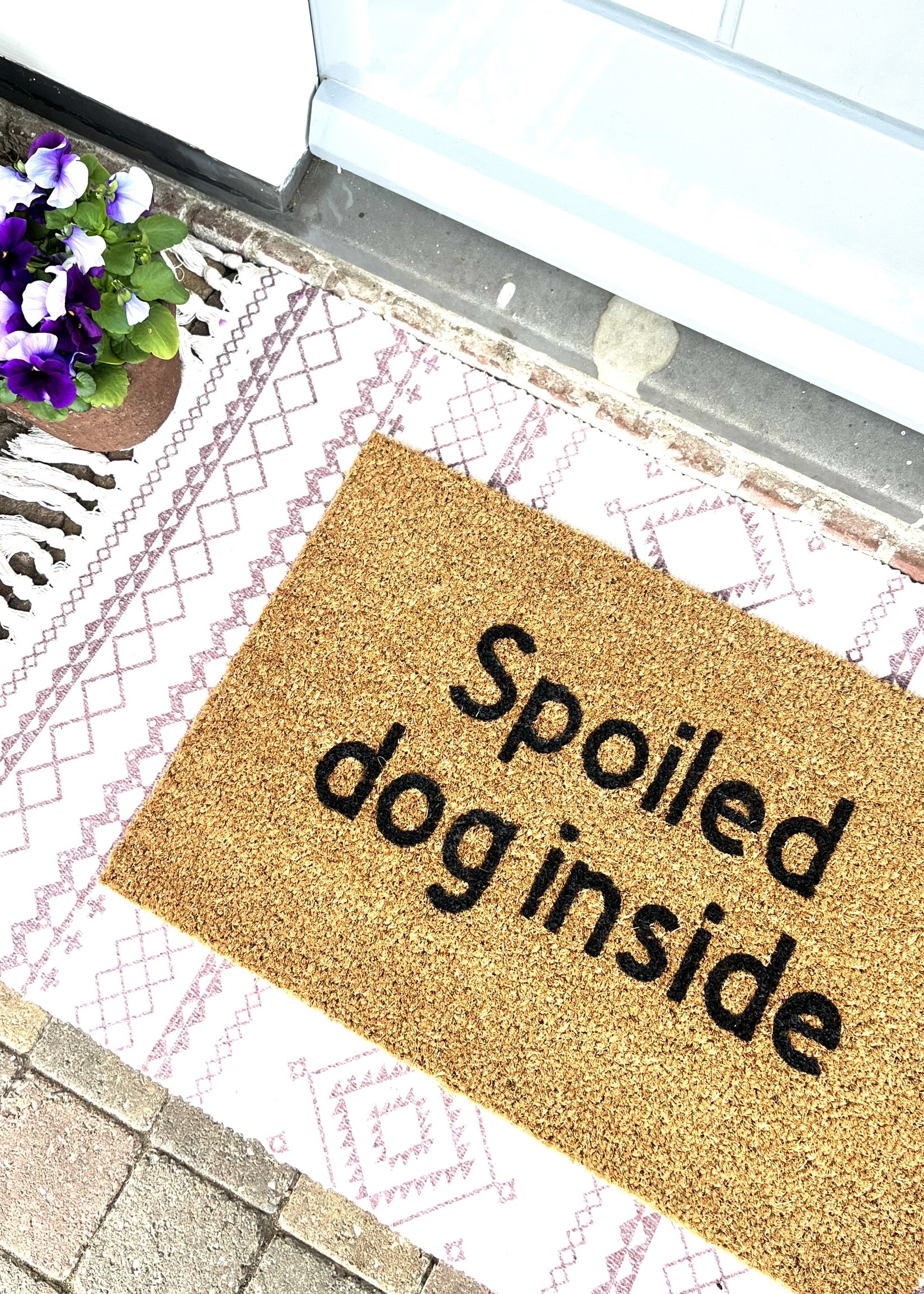 Spoiled dog inside doormat