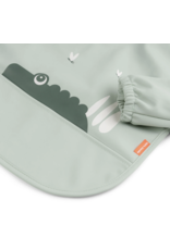 Done by Deer Sleeved pocket bib Croco Green Done by Deer Sleeved pocket bib Croco Green