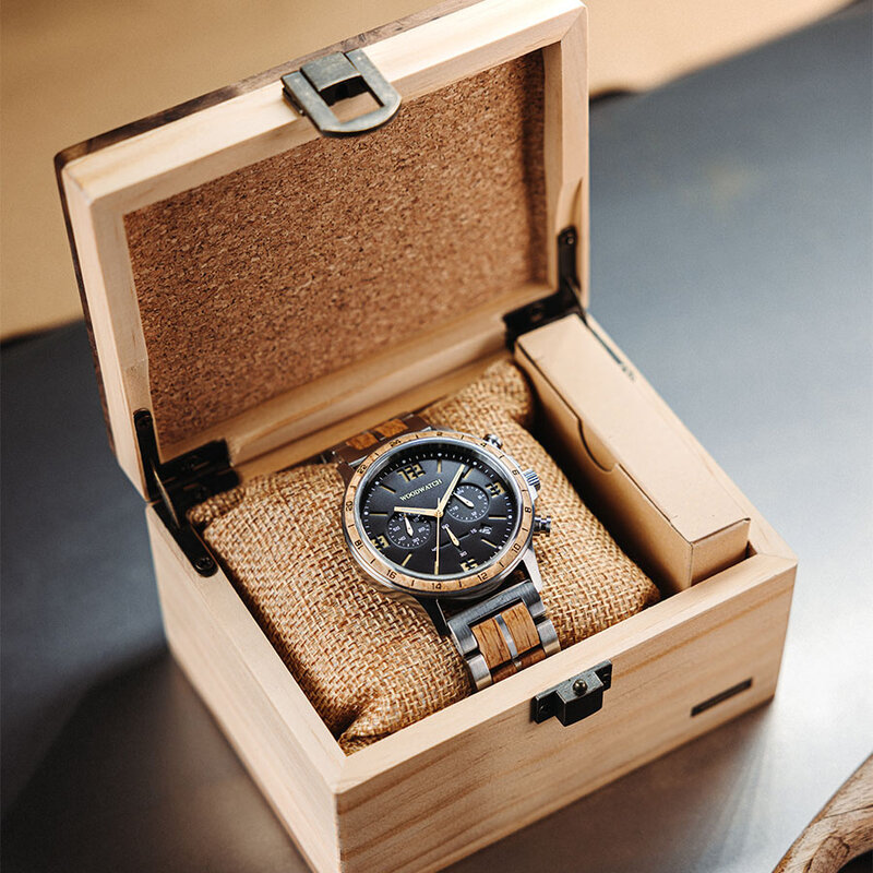 ساعة Craftmaster Dawn مصنوعة من خشب الجوز والفولاذ المقاوم للصدأ 304. تتميز بقرص أسود مع تفاصيل معدنية ذهبية وفضية.