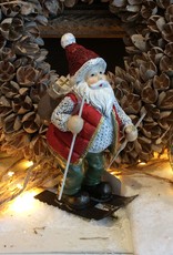 Père Noël sur des skis avec des cadeaux