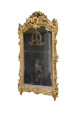 Maison Leon Van den Bogaert Antieke Franse Régence spiegel in verguld hout met origineel spiegelglas, rocaille snijwerk en warme gouden patina