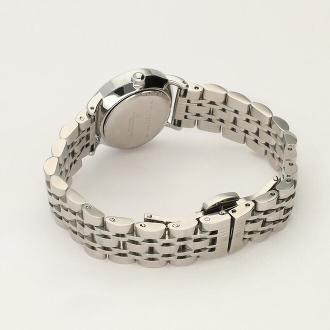 Round silver watch with a small white dial