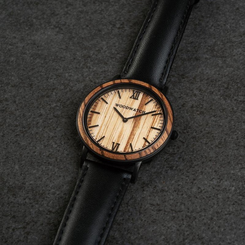 A combination of unique materials with a minimal design to create a timeless look. This modern watch suits both your casual day look and your finest formal wear. A super thin case made of the finest stainless steel with a matte black finish. A statement o