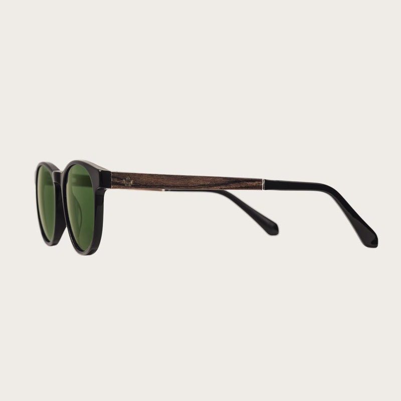 The ELLIPSE Black Camo features a characteristic rounded black frame with green camo lenses. Composed of durable Italian Mazzucchelli bio-acetate with hand-finished natural rosewood temples and black acetate tips. Bio-acetate is made from cotton and organ