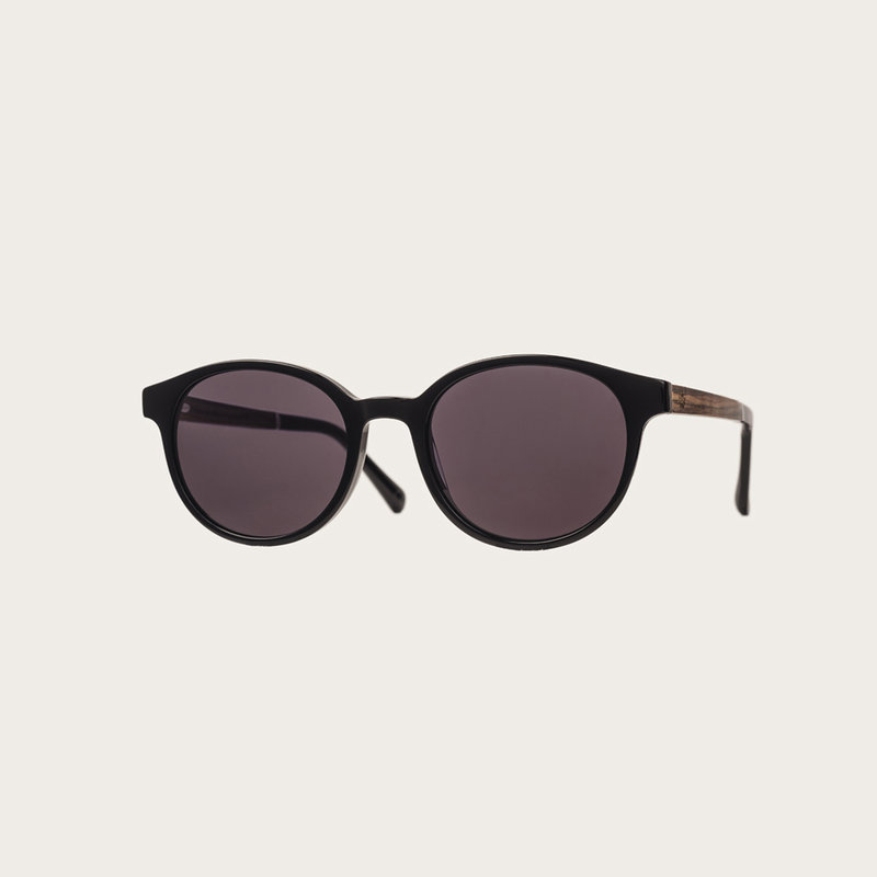 The SOHO All Black features an oval black frame with black lenses. Composed of durable Italian Mazzucchelli bio-acetate with hand-finished natural rosewood temples and black acetate tips. Bio-acetate is made from cotton and organic resins making our frame