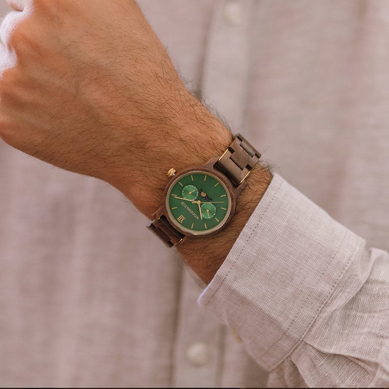 The men's CLASSIC Hunter watch has a classy slim case while featuring a unique moonphase movement and two extra subdials. The watch is made of North American Walnut Wood and features a green dial and golden-colored details. It is a perfect match with the