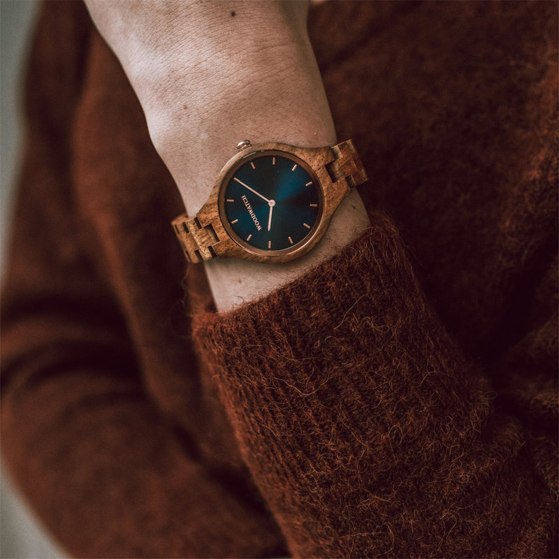 The AURORA Collection breaths the fresh air of Scandinavian nature and the astonishing views of the sky. This light weighing watch is made of East African Kosso wood, accompanied by a blue stainless-steel dial with shining rose gold details.The watch is a