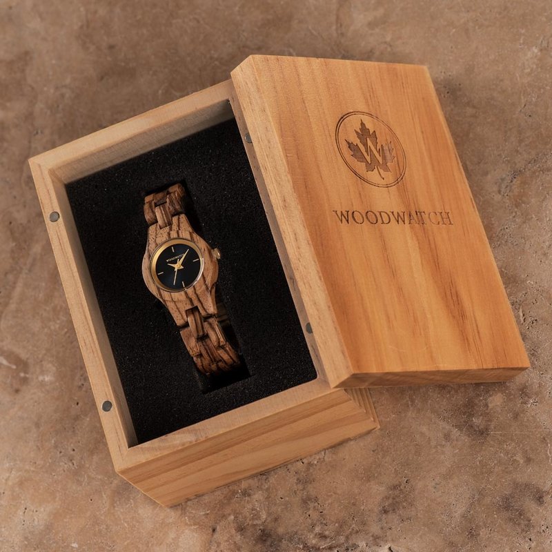 The Juniper watch from the FLORA Collection consists of Zebra wood that has been hand-crafted to its finest slenderness. The Juniper features a dark navy blue dial with golden coloured details.