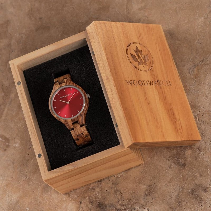The AURORA Collection breaths the fresh air of Scandinavian nature and the astonishing views of the sky. This light weighing watch is made of kosso wood, accompanied by a red stainless-steel dial. The watch is available with a wooden strap or a leather st